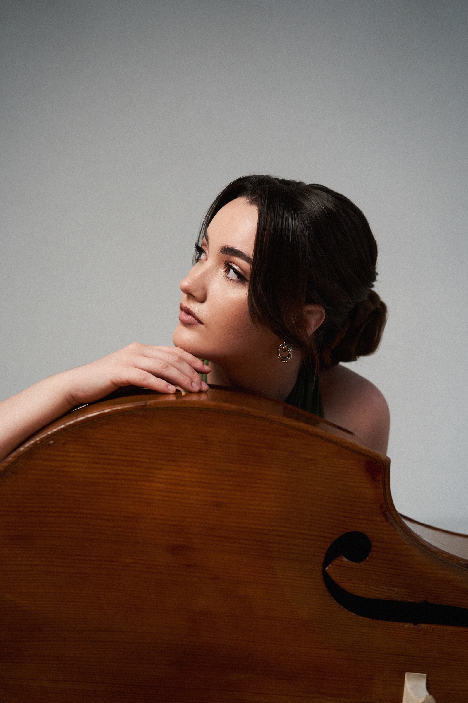Kateryna Hut resting against the body of her double bass