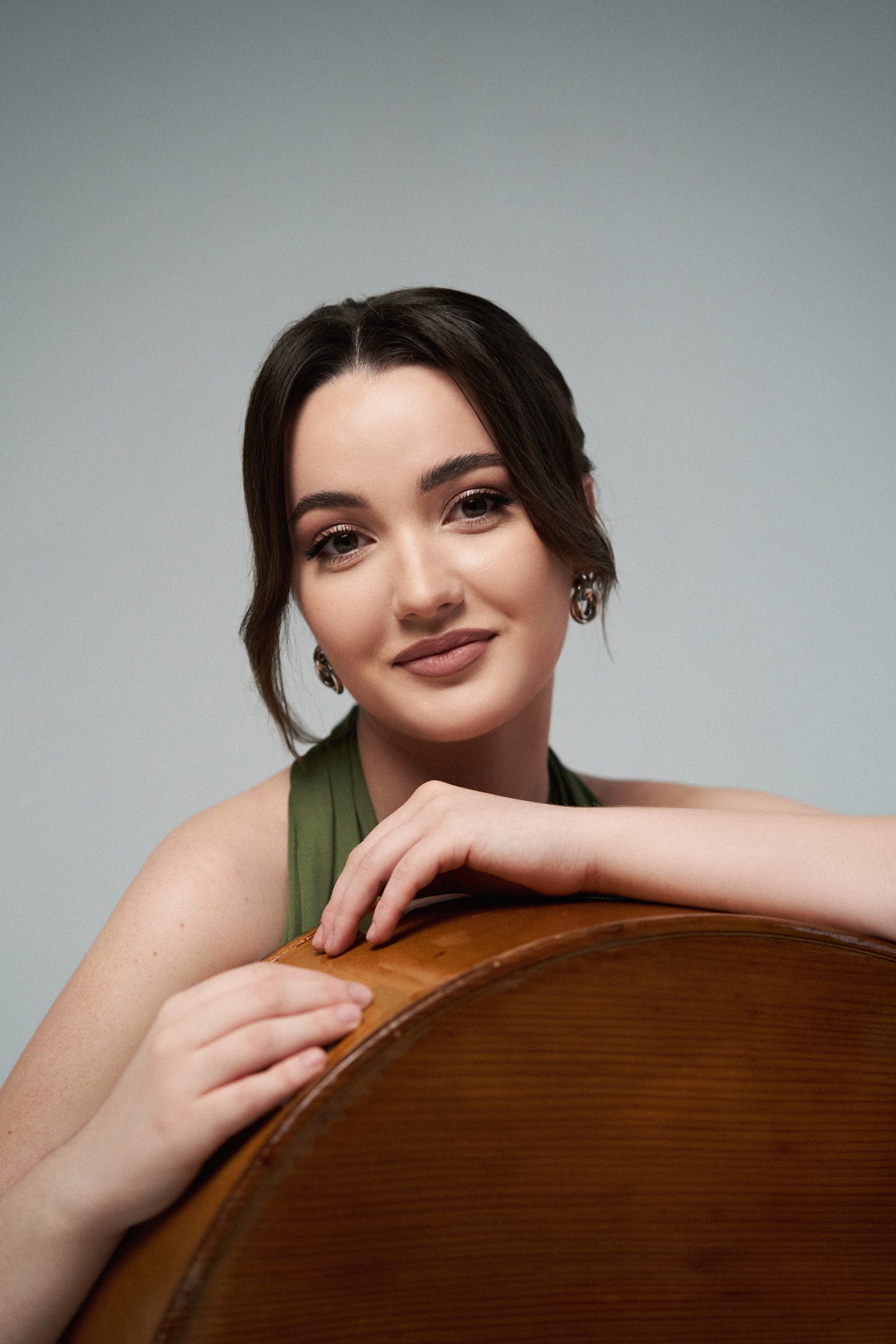 Portrait of Kateryna Hut leaning on the body of the bass